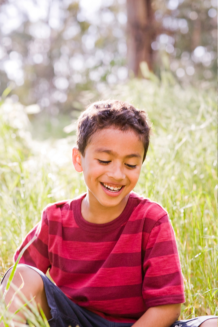 smiling boy in grass kid art director